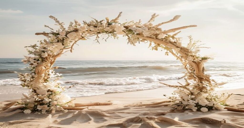 Serene beach wedding setting with a driftwood arch, symbolizing a beautiful destination wedding invitation website.